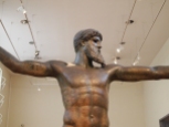 the bronze statue of Zeus or Poseidon, found in the sea off of Evia, which depicts one of the gods (no one really knows which one) with his arms outstretched and holding a thunderbolt or trident in his right hand